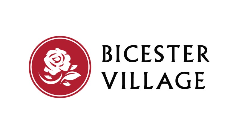 A logo of the Bicester Village, UK